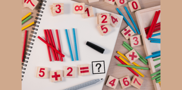 Math skills every first grader needs cover A variety of blocks and tiles showing number's are laid randomly on a desk top with pencils