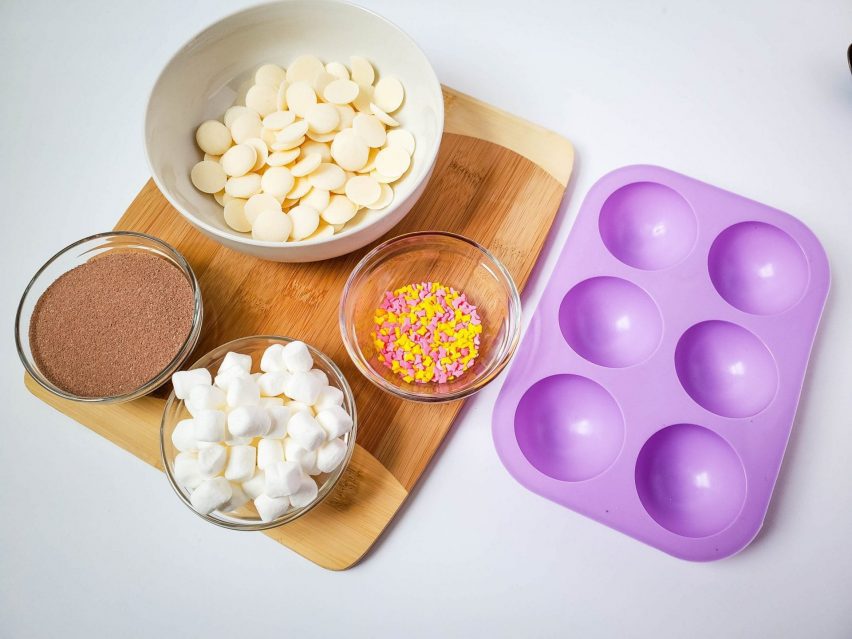 Ingredients and supplies to make white chocolate cocoa bombs
